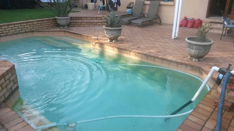 Pool before resurfacing, with green, algae-stained water