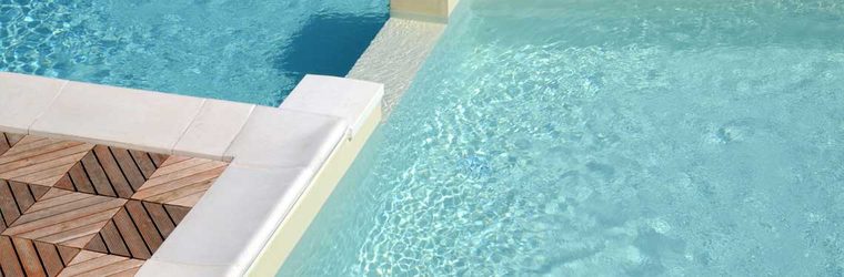 A well-maintained pool with clear water beside a timber deck